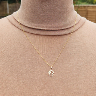sold gold earth charm pendant in 9ct