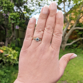sapphire and diamond flower ring on hand