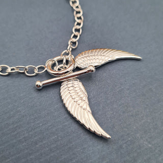 ladies silver bracelet with wing charms
