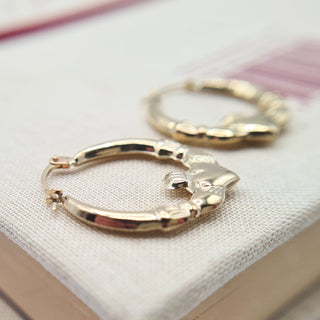 close up of claddagh creoles