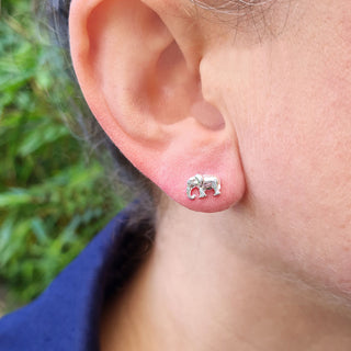 silver elephant earrings in ear