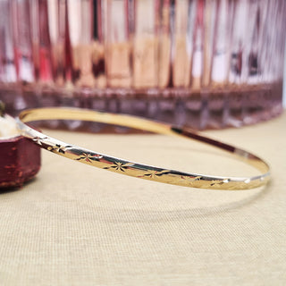 ladies 9ct yellow gold slim bangle with diamond cut design