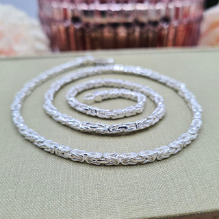 close up of square byzantine links on silver necklace
