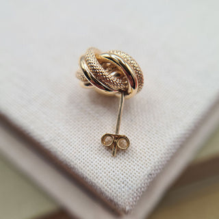 post and butterfly fitting on gold knot studs
