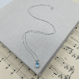 dainty topaz charm necklace in 9ct white gold