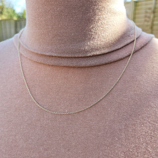 dainty solid gold trace chain being worn