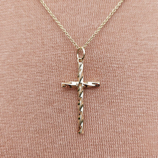 close up of gold twist cross