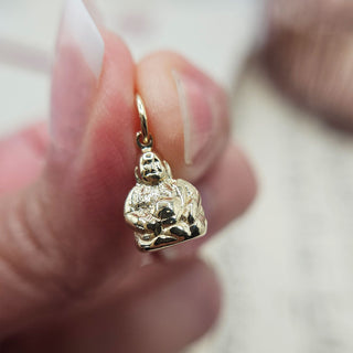 close up of dainty buddha charm
