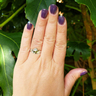 silver claddagh ring on hand