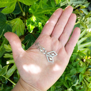 women's dress drop dangle earrings in hand for scale