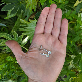 drop earrings with cz in hand for scale