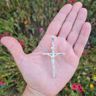 large crucifix in hand for scale