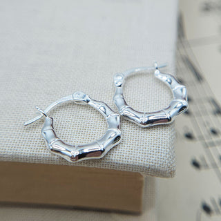 close up of bamboo styling on silver hoops