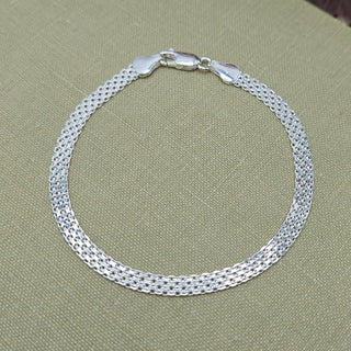 Sterling silver four strand Bismark bracelet with lobster clasp on neutral background