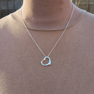 heart necklace in silver being worn