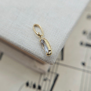 dainty gold charm set with white cz to imitate diamond