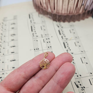 tree of life pendant in hand for scale