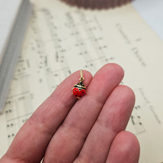 ladybird charm in hand for scale