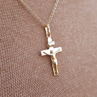 close up of crucifix pendant on the neck