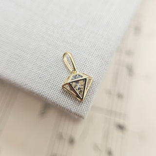 solid gold diamond-shaped charm