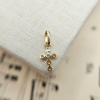 reverse side of tiny gold cross charm