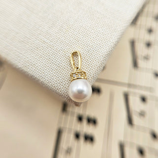 tiny pearl and cz charm in 9k gold