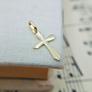 very small pointed gold cross pendant with diamond cut starburst 9ct