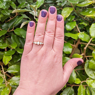 18ct five opal ring on ladies hand