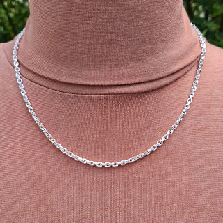 silver belcher chain on man's neck