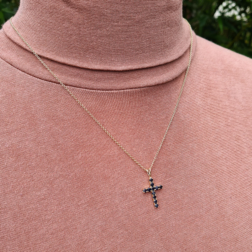 sapphire cross and chain being worn