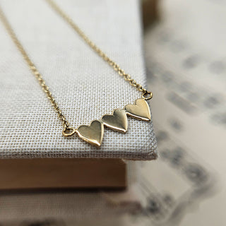 three hearts necklace in gold