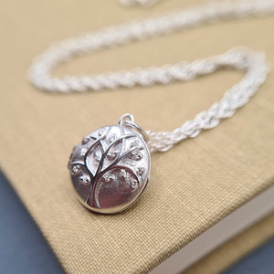 small round silver locket and chain