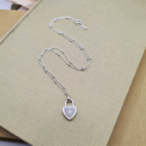 heart shaped padlock pendant studded with a diamond