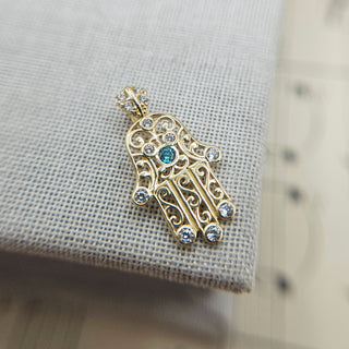 openwork filigree hamsa hand pendant in 9ct yellow gold