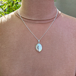 silver locket being worn