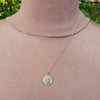 gold st christopher medal on neck