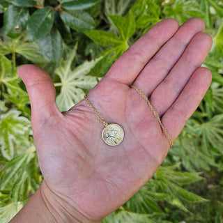 st christopher medal in hand for scale