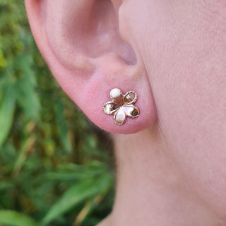 rose gold earrings in ladies ear