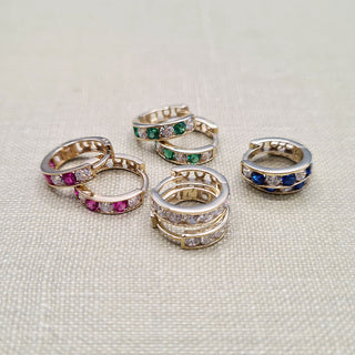 huggie earrings in ruby, emerald, sapphire and diamond colours