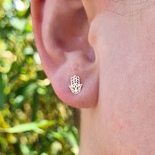 gold hamsa stud in ladies ear