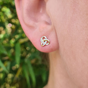 gold celtic knot earrings in womens ear