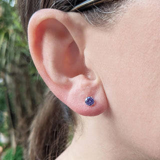 lilac coloured earrings being worn