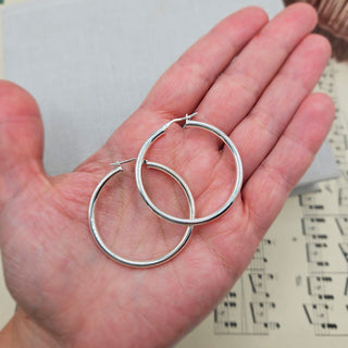 925 silver hoops in hand for scale
