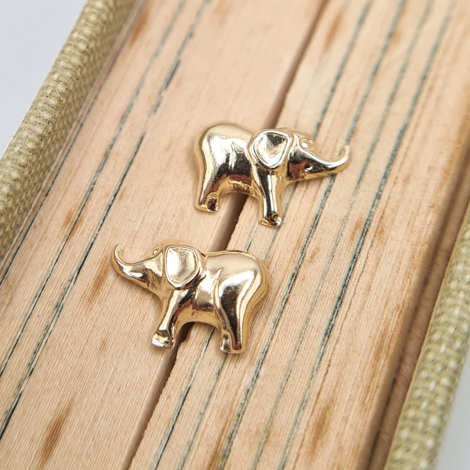 small elephant studs in yellow gold