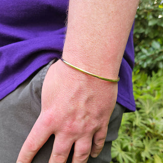 torque bangle on man's wrist