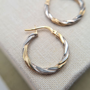 close up of multi tone gold earrings
