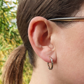 rose and white gold hoop earrings in ear