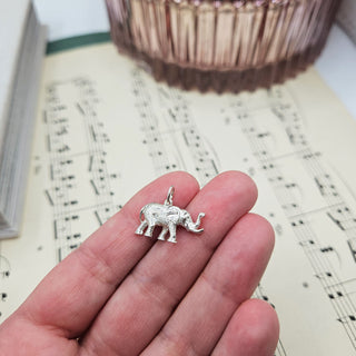hallmarked silver elephant in hand for scale