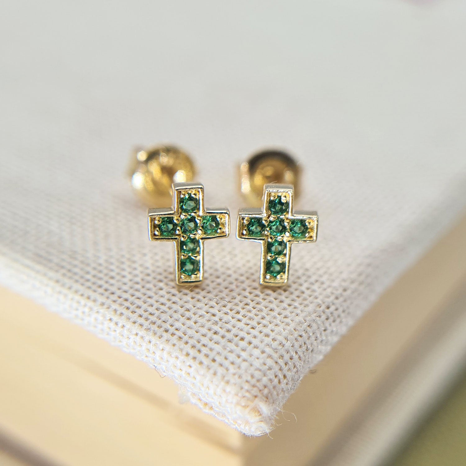 tiny emerald cross stud earrings in yellow gold