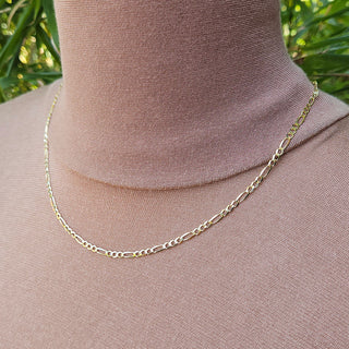 another view of gold figaro chain on neck